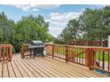 Wooden deck perfect for outdoor dining and entertaining, complete with a grill and fenced-in area at 2427 Cherry Cir, Brighton, CO 80601