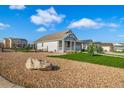 View of a home with a rock garden, manicured lawn, and inviting front porch at 42400 Forest Oaks Dr, Elizabeth, CO 80107