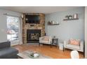 Relaxing living room featuring a corner fireplace, comfortable seating, and natural light at 2927 W 81St Ave # H, Westminster, CO 80031