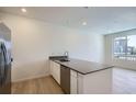 Bright kitchen with a center island, modern appliances, and large windows offering natural light at 14578 W 90Th Ln # B, Arvada, CO 80005