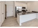 Modern kitchen with stainless steel appliances, a breakfast bar, and ample counter space at 14578 W 90Th Ln # B, Arvada, CO 80005