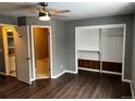Bedroom featuring hard wood floors, a ceiling fan, an ensuite bathroom and a closet at 20328 E Powers Ln, Aurora, CO 80015