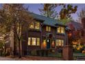 Dusk view of brick home highlighting the architectural details and warm interior lighting at 815 Gaylord St, Denver, CO 80206