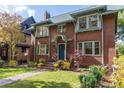 Beautiful brick home with a landscaped yard, featuring a vibrant, inviting facade at 815 Gaylord St, Denver, CO 80206