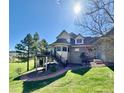 This backyard features a large deck and beautifully landscaped greenery at 5 Catamount Ln, Littleton, CO 80127