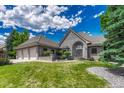 Charming single Gathering home with brick exterior, manicured lawn, and three-car garage at 5 Catamount Ln, Littleton, CO 80127