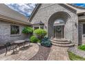 Stunning front entrance with brick steps, walkway and cozy sitting area at 5 Catamount Ln, Littleton, CO 80127