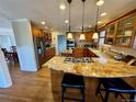 Open kitchen with granite countertops, stainless steel appliances and wooden floors at 5 Catamount Ln, Littleton, CO 80127