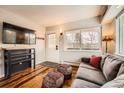 Comfortable living room with TV, sofa and rustic decor elements that create a warm atmosphere at 1941 Boreas Pass Rd # 1C, Breckenridge, CO 80424