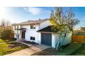 Well-maintained home with green lawn, attached garage, and a mature tree in the front yard at 846 E 114Th Pl, Northglenn, CO 80233