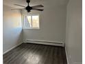 Clean bedroom with wood-look floors, a ceiling fan, and a window with a view at 1285 N Colorado Blvd # 4, Denver, CO 80206