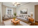 Comfortable living room with gray sofas, ceiling fan and natural light at 4072 Ames St, Wheat Ridge, CO 80212