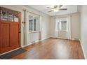Bright living room with hardwood floors, ceiling fan, and natural light from two windows at 4072 Ames St, Wheat Ridge, CO 80212