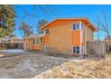 Charming orange brick home with a well-maintained lawn and vibrant blue sky at 3164 Scranton St, Aurora, CO 80011