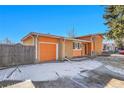 Charming orange brick home with attached garage and driveway at 3164 Scranton St, Aurora, CO 80011