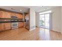 Well-equipped kitchen boasts stainless steel appliances, ample cabinetry, and access to a balcony at 8751 Pearl St # D1, Thornton, CO 80229