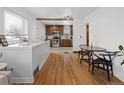 Dining Area open to the kitchen with hardwood floors and natural light at 1777 Spruce St, Denver, CO 80220