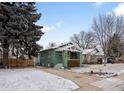 Quaint home featuring a neat driveway, mature trees and snow-dusted lawn at 1777 Spruce St, Denver, CO 80220