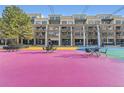 Condo exterior with colorful outdoor recreation area, tables, and chairs at 7220 W Bonfils Ln # 206, Lakewood, CO 80226