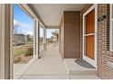 View of the front porch of a brick home, leading to the front door at 631 E Hinsdale Ave, Littleton, CO 80122