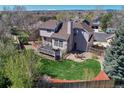 Backyard aerial showcasing a large deck, green lawn, and fire pit seating area in a fenced yard at 12646 S Dove Creek Way, Parker, CO 80134