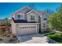 Beautiful two-story home with stone accents, a well-manicured lawn, and a two-car garage at 12646 S Dove Creek Way, Parker, CO 80134