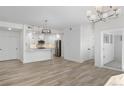Open-concept living and kitchen area with plank flooring and modern finishes at 1308 Snowberry Ln # 303, Louisville, CO 80027