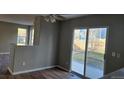 Open-plan living area with sliding glass doors to the outside patio and hardwood floors at 5956 S Winnipeg St, Aurora, CO 80015