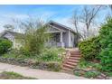 Charming home featuring a covered front porch with a cozy and well-kept front yard landscape at 1920 S Downing St, Denver, CO 80210