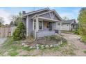 Charming home featuring a covered front porch with a cozy and well-kept front yard landscape with rocks at 1920 S Downing St, Denver, CO 80210