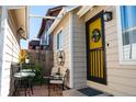 Inviting back patio area with outdoor seating and a decorative yellow door entrance at 19044 E 16Th Ave, Aurora, CO 80011
