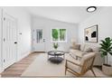 Bright living room with neutral tones and modern decor, perfect for relaxing and entertaining at 4556 S Pagosa Way, Aurora, CO 80015