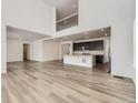 Open-concept living room showcasing hardwood floors, a modern kitchen, and a second story landing at 39877 Floyd St, Elizabeth, CO 80107