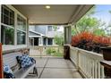 Cozy covered porch with comfortable seating, perfect for relaxing outdoors at 13025 Umatilla Ct, Denver, CO 80234