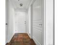 Bright hallway with tile flooring, white doors, and contemporary lighting at 1705 Gaylord St # 201, Denver, CO 80206