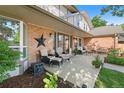 Inviting covered porch features brick accents, seating, and decorative details, perfect for outdoor relaxation at 7830 W Friend Pl, Littleton, CO 80128
