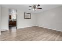 Bright living room with wood-look flooring and ceiling fan, ready for customization and comfort at 3224 S Dudley St, Lakewood, CO 80227