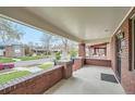 Covered front porch features brick pillars and a view of the street at 586 S Corona St, Denver, CO 80209