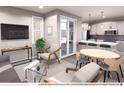 Modern living room with natural light, stylish furniture, and an open layout to the kitchen at 1569 W 166Th Ave, Broomfield, CO 80023