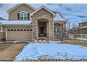 Charming front entrance featuring an arched doorway and space for decorative planters at 14096 Roaring Fork, Broomfield, CO 80023