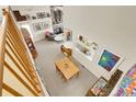 Open-concept living room and dining area with a vaulted ceiling and natural light at 6360 S Gibraltar Cir, Centennial, CO 80016