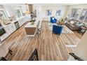 Open concept living space with a gourmet kitchen, cozy living area and hardwood floors, offering modern comfort at 13232 W Jewell Cir, Lakewood, CO 80228