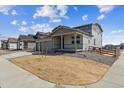 Well-kept exterior of the two story home with a two car garage and fenced in front yard at 14366 Heritage Dr, Mead, CO 80504