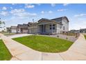 Inviting home showcasing a cozy front porch, a manicured lawn, and a charming neighborhood street view at 14366 Heritage Dr, Mead, CO 80504