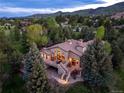 Breathtaking aerial view of the beautiful home nestled among mature trees, showcasing the serene and private setting at 5904 Meadowbrook Dr, Morrison, CO 80465
