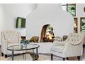 Inviting living room with a cozy fireplace, comfortable seating, and a view of the greenery outside at 5904 Meadowbrook Dr, Morrison, CO 80465