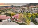 Expansive aerial view showcasing the home's tile roof and location in a picturesque neighborhood with mountain views at 6321 Spotted Fawn Run, Littleton, CO 80125