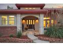 Inviting front entrance with a tiled porch, decorative door, and manicured landscaping offering a warm welcome at 6321 Spotted Fawn Run, Littleton, CO 80125