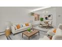 Inviting living room features a comfortable sofa, patterned rug, and adjacent dining area for easy living at 1149 Columbine St # 202, Denver, CO 80206