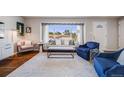 Open living room boasts hardwood floors, large windows, and neutral paint, creating an inviting atmosphere at 6924 S Albion St, Centennial, CO 80122